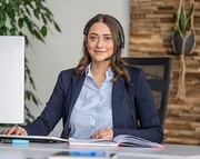 A customer support representative wearing a headset at her desk.